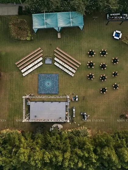 Our meticulous planning is visible from every angle. This aerial view reveals the precision of our event architecture, showcasing a symmetrical layout with designated zones for seating, performance, and guest interaction, ensuring optimal flow for a large-scale outdoor corporate event.