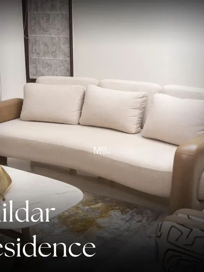 A full view of the sofa we designed for the Zaildar Residence. Draped in a soft, plush fabric with contrasting leather armrests, it strikes the perfect balance between cozy comfort and contemporary style.