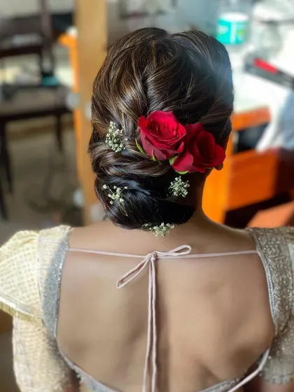 Another view of the soft textured bun with red roses, created for the mother of the bride. It’s a classic and elegant choice that never goes out of style.
