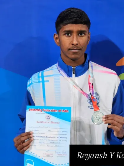 Reyansh Y Kanthi proudly shows his silver medal and certificate.