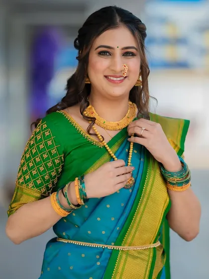 Her smile says it all. The soft glam makeup and beautiful saree create a look that is both elegant and joyful.