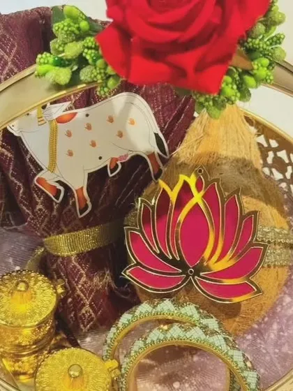 A detailed shot focusing on the upper portion of the basket, showing the fresh flower accent and the arrangement of the coconut and blouse piece.