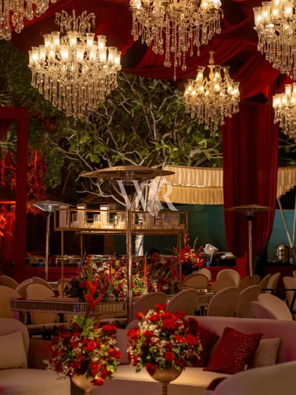 A detail of the lounge seating at the Sufi night. The deep red florals and crystal chandeliers are reflected in the mirrored tables, amplifying the richness and opulence of the decor.