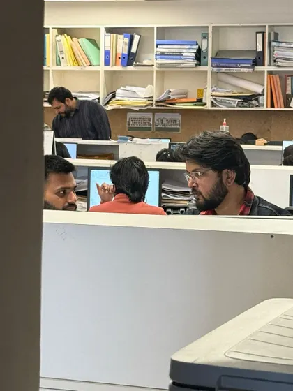 An impromptu discussion between team members in the studio. This culture of open communication and constant feedback is where some of our best ideas are born.