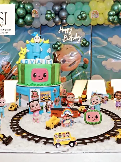 Another view of the detailed Cocomelon cake and marquee letters spelling out the birthday boy's name, Advait.