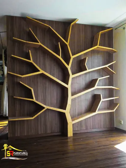 This tree-shaped bookshelf is a perfect example of how we turn a client's unique vision into functional art. Custom-built from plywood with a light wood finish against a dark veneer backdrop, it serves as a stunning focal point and a practical display unit in this room.