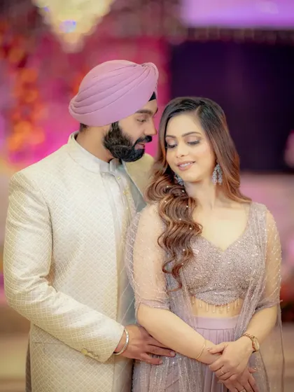 An intimate and loving portrait. Sanjit looks down at Simran with adoration, his arm around her, capturing a quiet moment of affection during their Roka celebration.