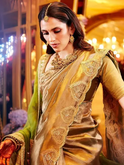 A close-up capturing the beautiful drape of the Masaba saree and the intricate gold jewelry. This is fusion heritage styling at its most meaningful.