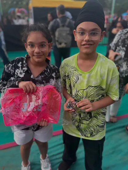 Two happy siblings with their custom-made goodies from my live event.