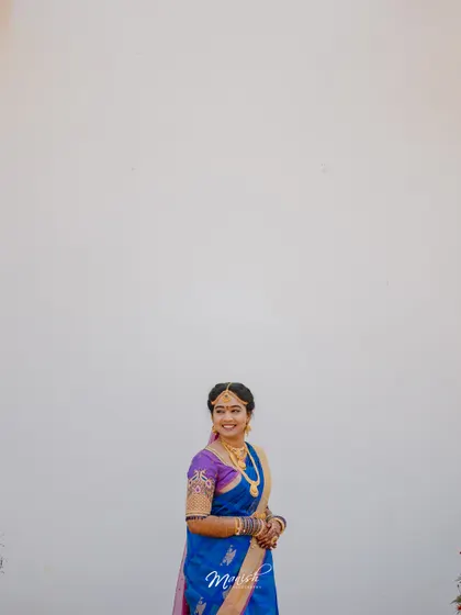 A minimalist portrait of the beautiful South Indian bride in her traditional blue and purple silk saree.