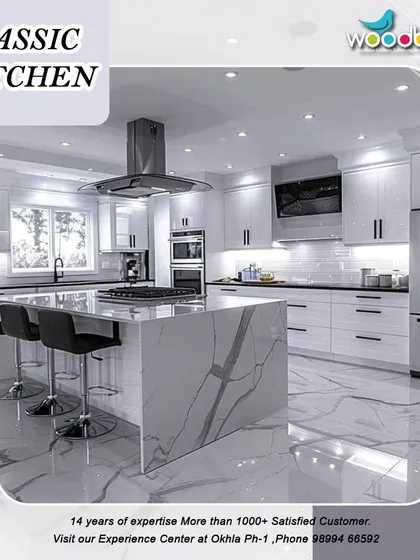 A classic white kitchen with a modern twist. This design features a large island with a waterfall countertop, providing a perfect space for cooking and entertaining.