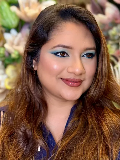 A side profile showing the beautiful blending of the teal shadow. Makeup is about character, and this look has plenty.