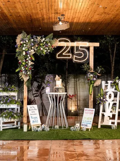 The full view of the rustic and romantic 25th birthday setup. The wooden structure, neon sign, and carefully placed props created a perfect photo-worthy stage for the milestone celebration.