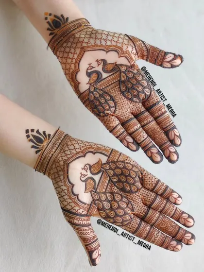 A clean and elegant design focusing on twin peacocks on the palms, framed by a simple net pattern and a lotus motif on the wrist.