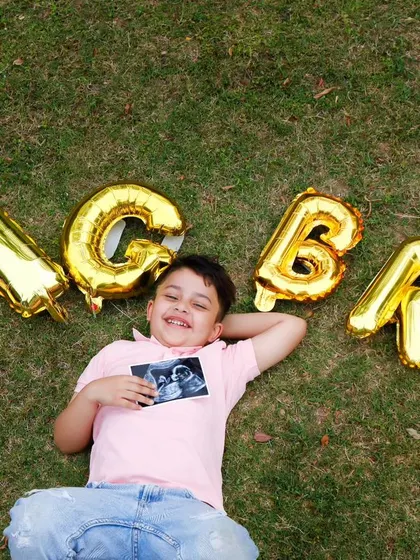 A creative and joyful pregnancy announcement. The "BIG BRO" balloons and the sonogram picture tell a beautiful story of a growing family.