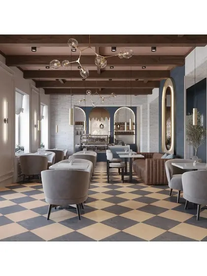 This cafe design has a classic European feel, with a checkered floor, exposed ceiling beams, and elegant grey armchairs. The space feels bright, airy, and timeless.