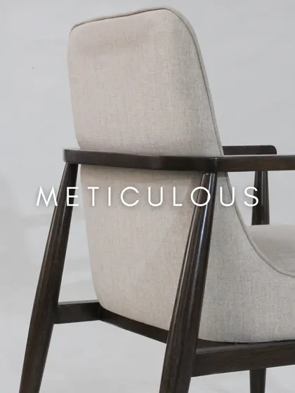 A detail of the chair's back, showing the elegant joinery and the smooth finish of the wood.