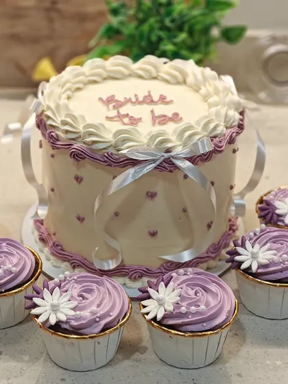 I'm obsessed with vintage cakes, and this "Bride to be" design is a perfect example. I used intricate piping techniques and delicate ribbons to create this elegant look for a special bridal shower. The flavor inside is my popular white chocolate and mixed berries.