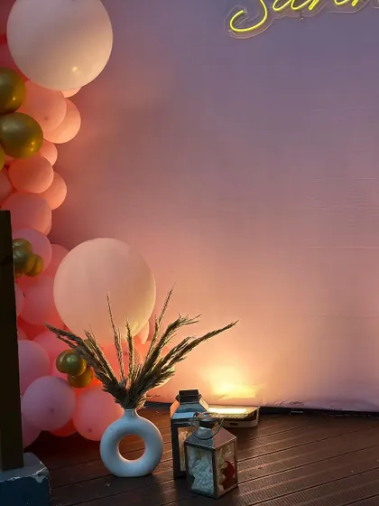 The soft lighting and minimalist decor details create a sophisticated and warm atmosphere for an intimate birthday gathering.