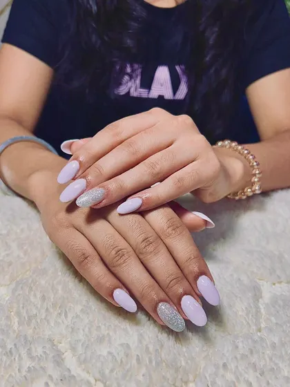 A lovely set of light purple almond-shaped extensions with a full-coverage silver glitter accent nail.