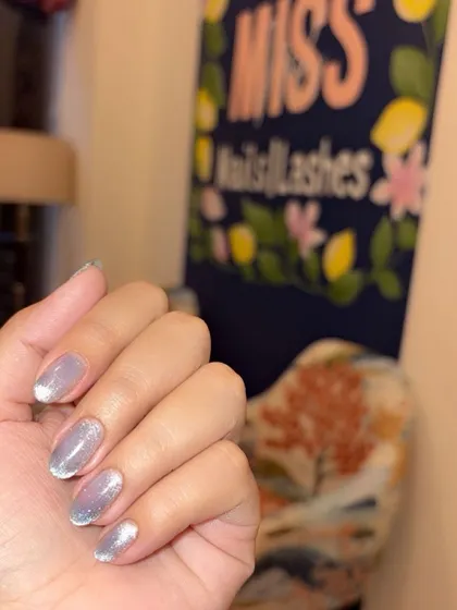 The cat eye nails seen against our salon's branding.