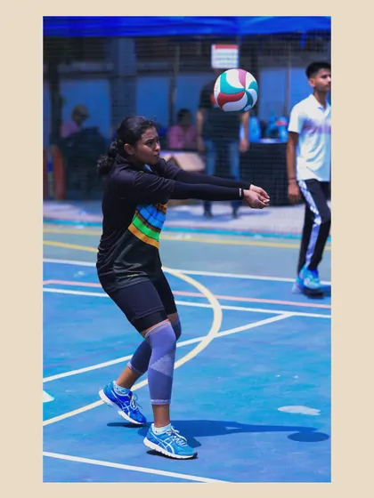 A female player executes a pass with perfect form. Her focus and technique are a result of dedicated practice and expert coaching.