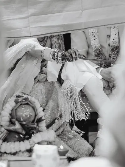 A detail-oriented shot of a wedding ritual, captured in artistic black and white to emphasize the tradition and significance.
