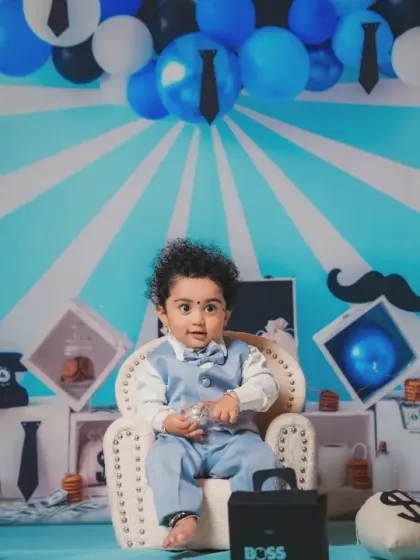 The boss in his chair. Our Boss Baby setup comes complete with money bags, a briefcase, and a cool blue backdrop.