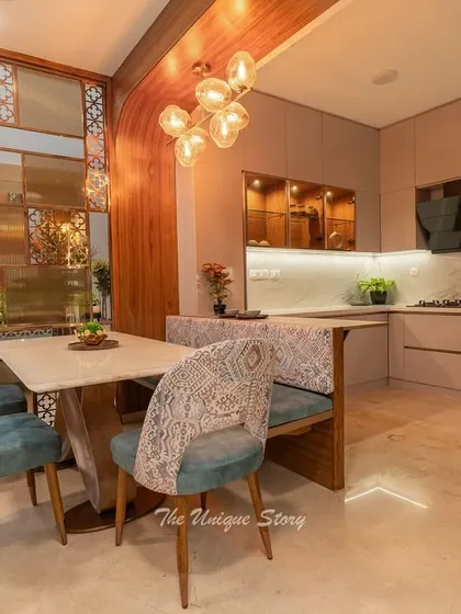 The kitchen includes a cozy breakfast nook with upholstered bench seating, seamlessly integrated with the dining area. This design encourages casual family meals and conversations.