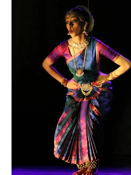 A playful expression with hands on hips, portraying the fun-loving and sometimes sassy nature of the Gopikas in their interactions with Krishna.