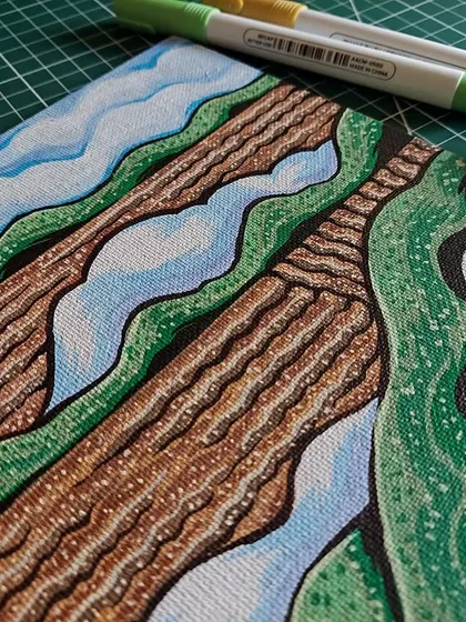 A different angle of the landscape painting, showing the texture of the canvas and the layers of marker ink.