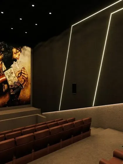 A perspective from the side of the auditorium, showing how the wall-mounted speakers are integrated into the design.