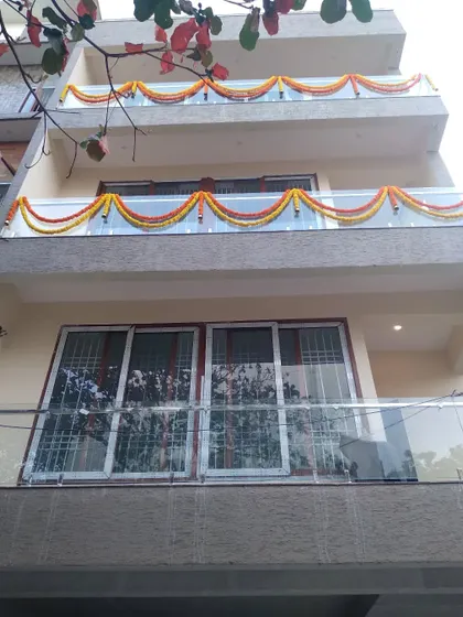 Simple marigold garlands used to decorate the balconies of a building for a housewarming or festival.