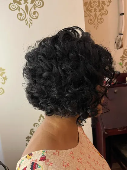A short curly bob with bangs for Darshana, proving you can do a lot with short curly hair.