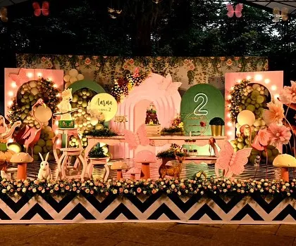 An enchanted garden party that glows with magic. I use string lights, hanging lanterns, and custom fairy and mushroom props to turn a simple lawn into a whimsical forest setting, perfect for an evening celebration.