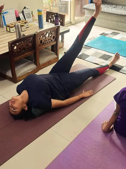 A young girl practices a core-strengthening exercise, building a strong foundation for all other movements.