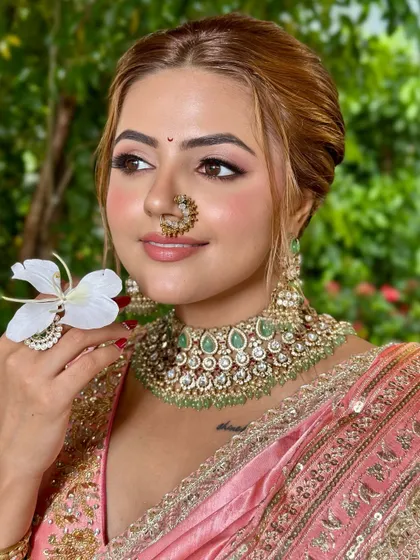 The traditional nath and bindi paired with modern, soft makeup. This look is all about celebrating heritage with a contemporary twist.