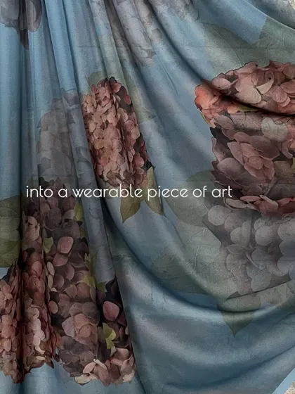 A fabric dream, painted with the gentle hues of a flower. This image shows the final printed fabric, a beautiful blue organza with hydrangea motifs.