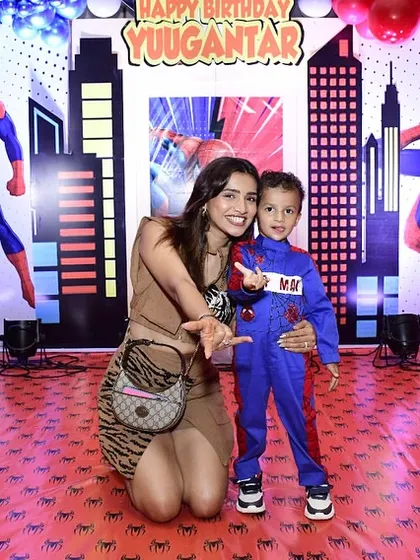 The birthday boy dressed as Spider-Man, posing with his mom. I love helping families create these precious, themed memories.