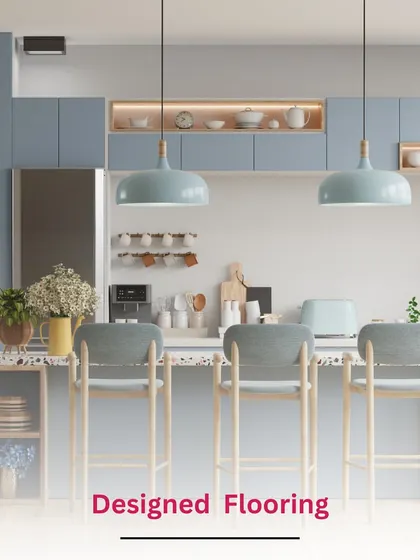 This kitchen idea features a large island with bar seating and designed flooring that defines the kitchen area. The soft blue cabinets and pendant lights create a calm, coastal vibe.