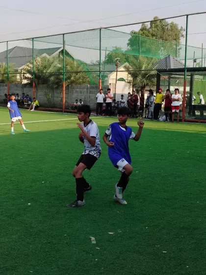 Two of our players show their competitive spirit and camaraderie during a break in play. We encourage our athletes to play hard but also enjoy the game and support their teammates.