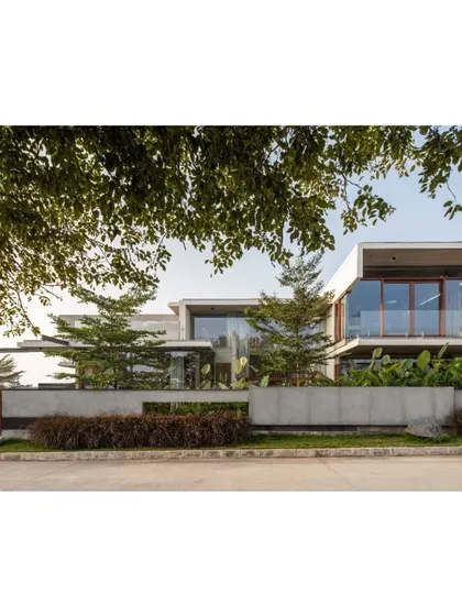 A duplicate of image 69, this photo shows the finished exterior of The Quarry House, where architectural volumes are framed by nature, creating a picture of modern living in harmony with the environment.
