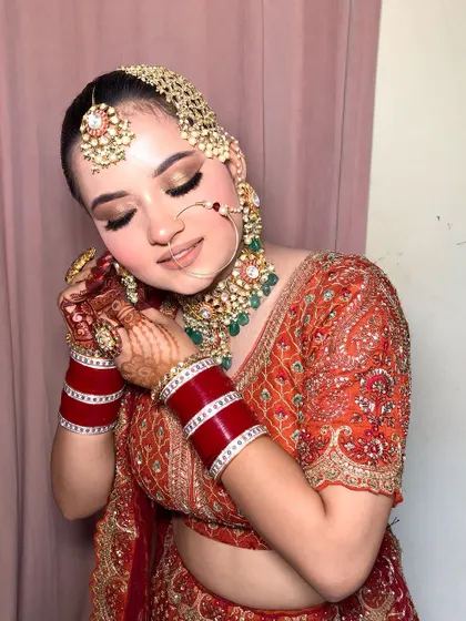 The complete look, with a beautiful smile. Her traditional jewelry, including the passa and nath, adds a regal touch to the entire ensemble.