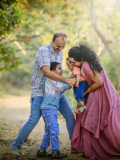 A candid moment of family fun, with everyone engaged in a group hug. The genuine laughter and interaction are what make this photo so heartwarming.