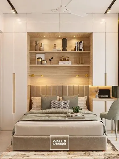 We designed this master bedroom as a complete sanctuary, integrating floor-to-ceiling wardrobes with a built-in headboard shelf and a compact study nook. The warm wood tones, soft backlighting, and plush upholstery create a luxurious and restful environment.