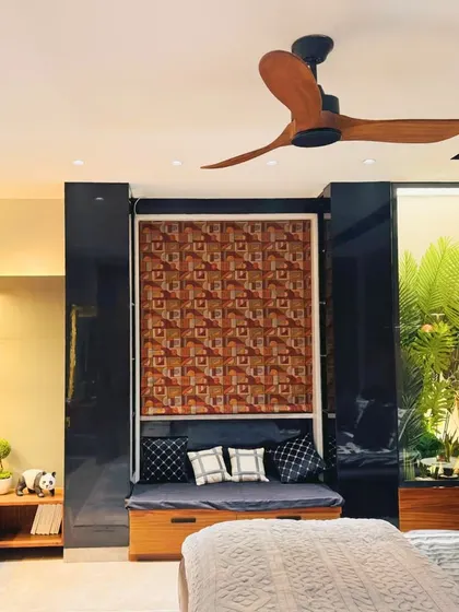 This view shows the bedroom's layout, including the built-in window seat and the seamless integration of the TV and storage unit, creating a multi-functional and cohesive space.
