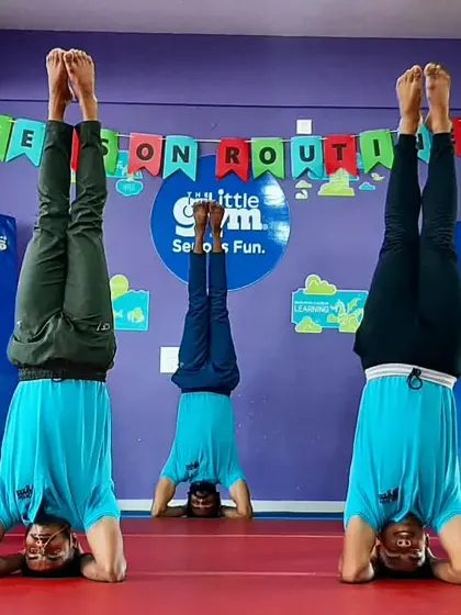 Our instructors showing off their strength and balance with synchronized headstands for International Yoga Day.