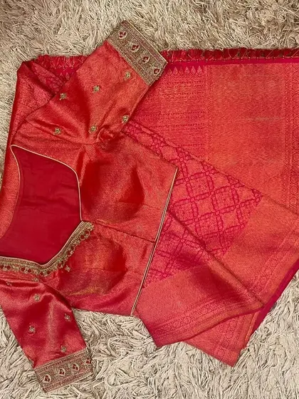 A classic pink silk saree and matching embroidered blouse, a timeless choice for any festive occasion.