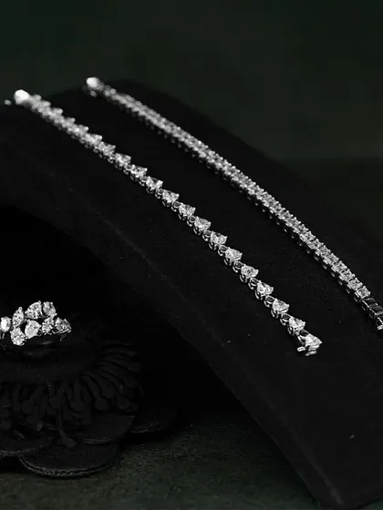 Feel the beauty of understated luxury with the minimal design and maximum sparkle of these diamond accessories, including two tennis bracelets and a matching ring.