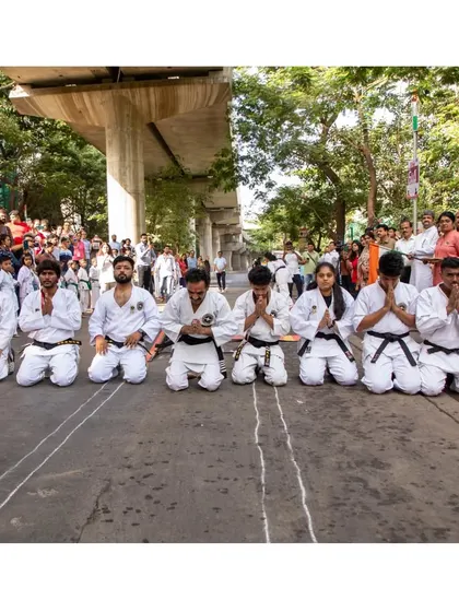 My senior students kneeling in a show of respect and support before my record attempt. This is the discipline and unity we foster at our academy.